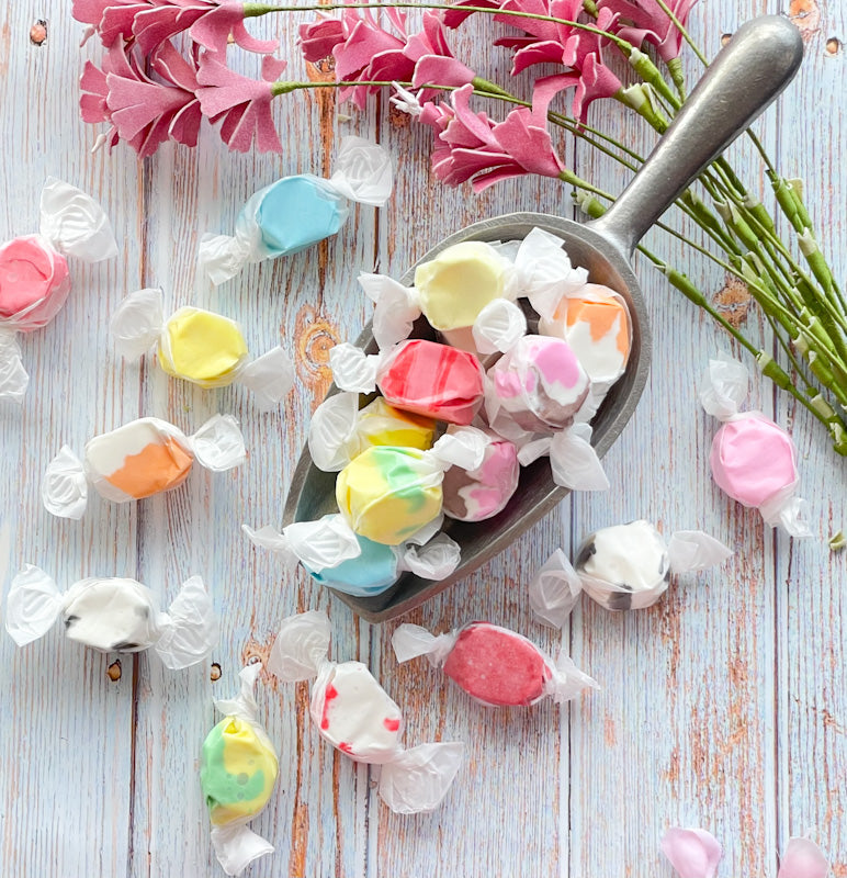 Assortment of taffy colors and flavors including State Fair, Cinnamon, Cherry, Black Licorice, Cotton Candy, Pear, Neopolitan, Banana, Peppermint, and Orange Vanilla