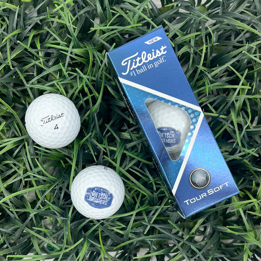 Three pack of white Titleist golf balls with blue Dietsch Brothers Logo