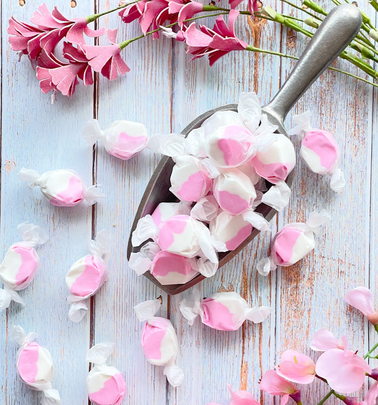 Strawberries and Cream taffy that displays a split of white and a light pink color.