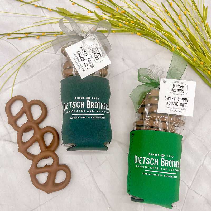 Dark green and light green koozie with white Dietsch Brothers logo, filled with milk chocolate covered pretzels