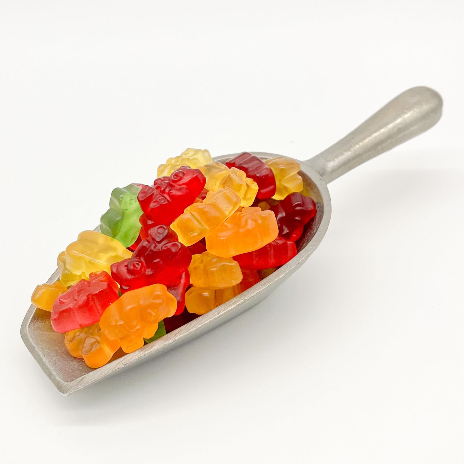 Metal scoop holding fruit flavored gummi bears