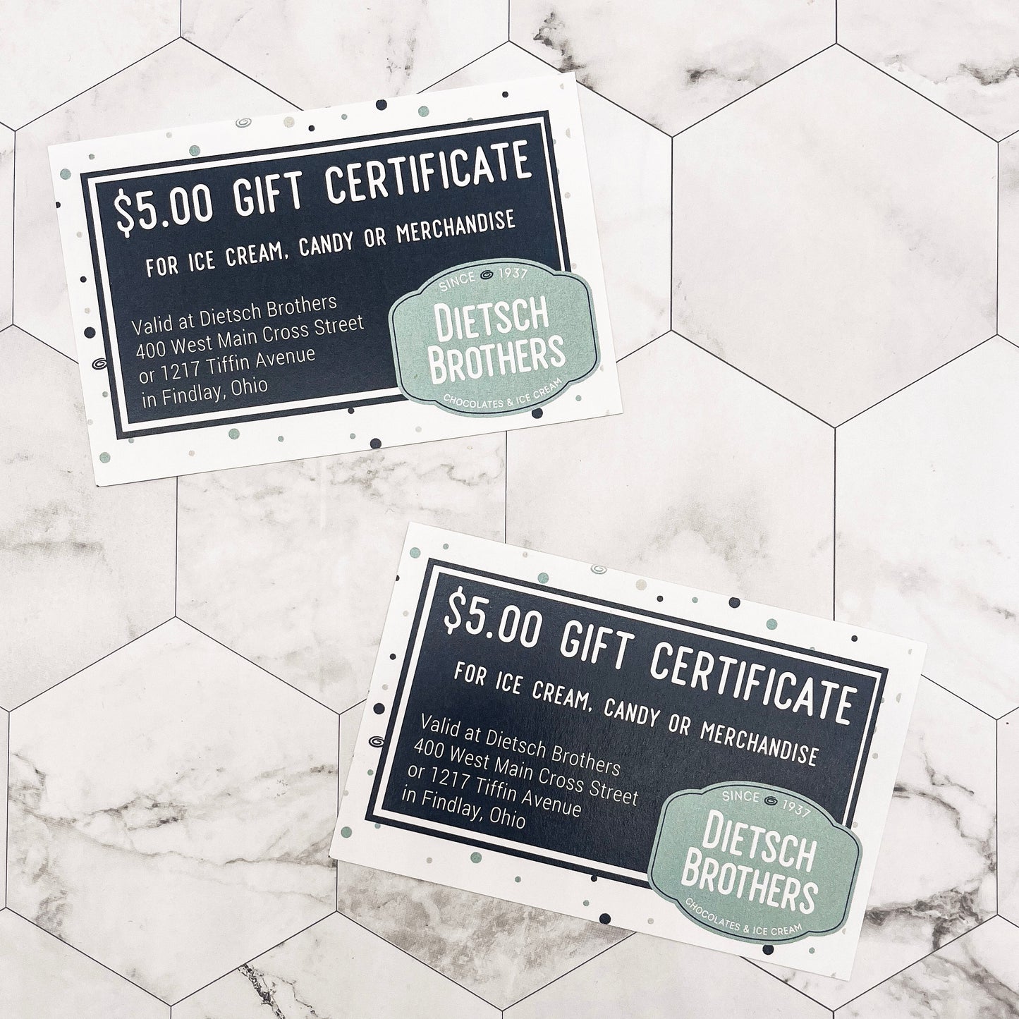 Two Dietsch Brothers gift certificates on a marble surface