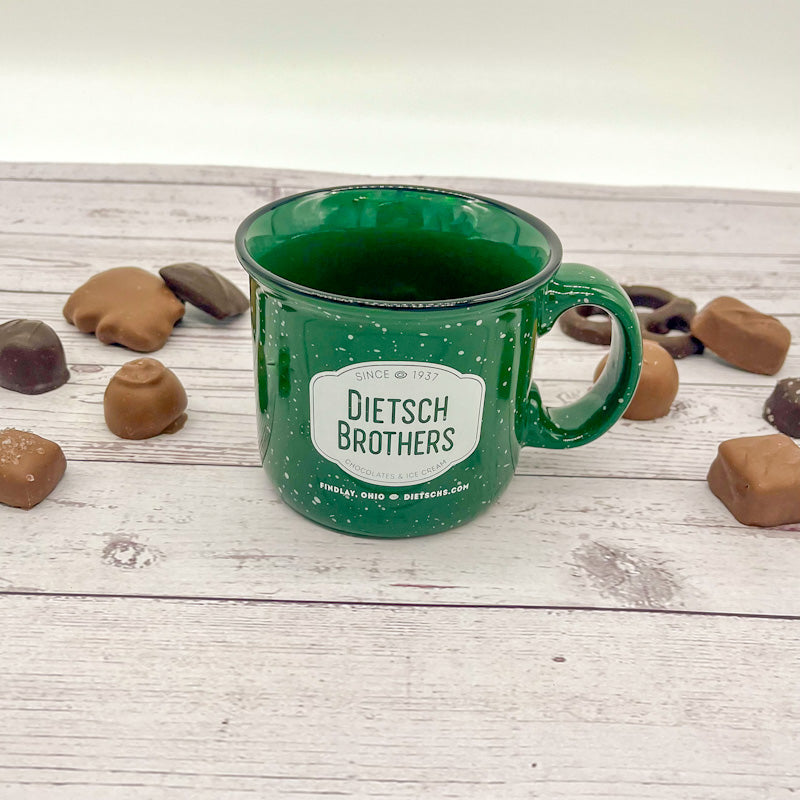 White spotted green mug with white Dietsch Brothers logo
