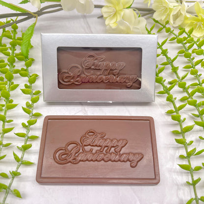 Milk chocolate bar that features a raised text "Happy Anniversary" across it