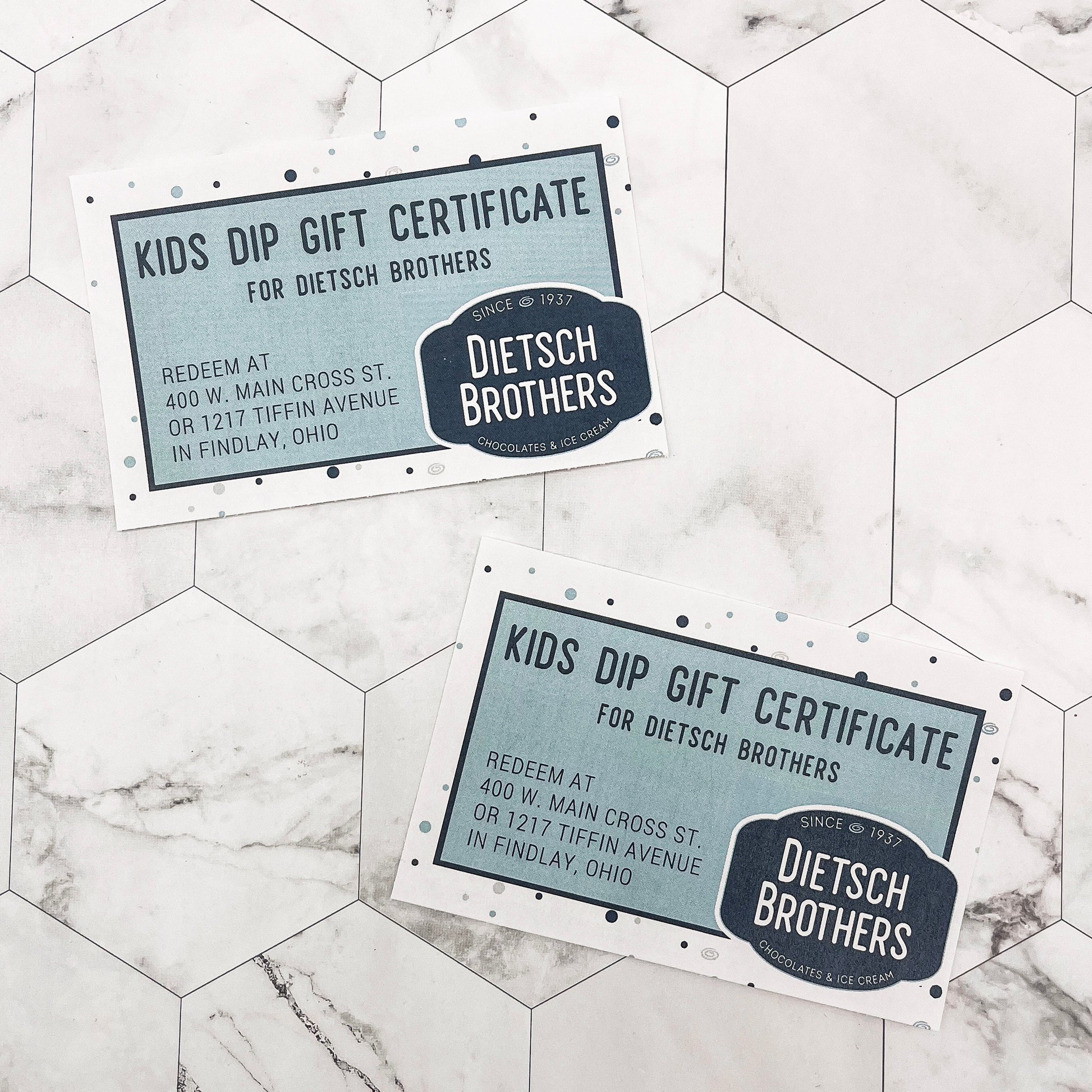 Two Dietsch Brothers Kids Dip Gift Certificates on a marble surface