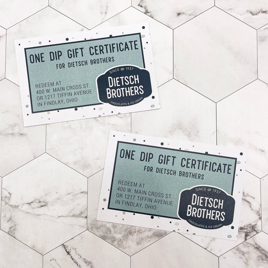Two Dietsch Brothers gift certificates on a marble surface