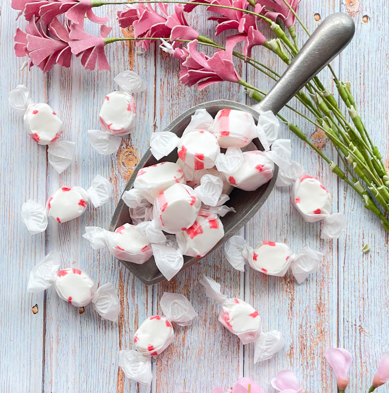 Peppermint taffy that features a white center with red and white stripes around the outer layer.