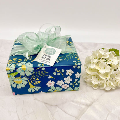 Pretzel gift box wrapped in blue floral paper and a mint green bow