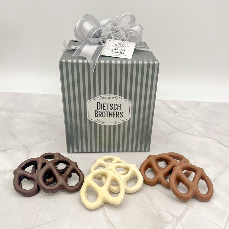 Pretzel package wrapped in striped silver and grey paper and a silver bow