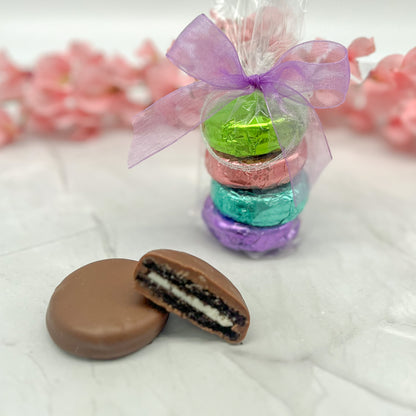 Four-piece pastel foil wrapped milk chocolate oreos in clear bag and tied with a colored purple bow