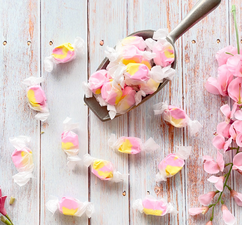 Strawberry Banana Taffy that is split colors between yellow and a light pink.