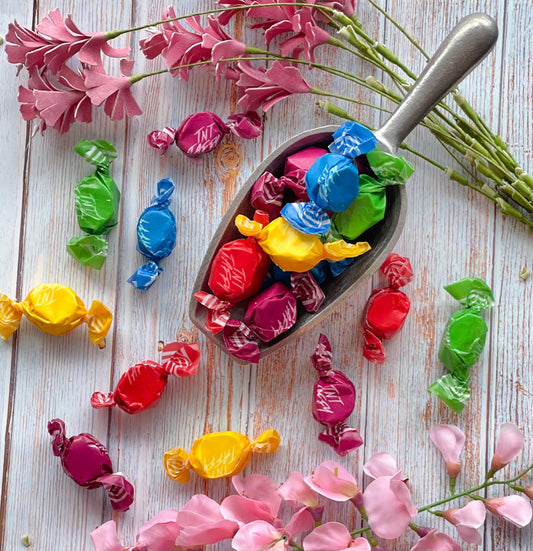Tart and Tangy taffy that features purple, blue, green, yellow, and red wrapped taffy pieces.