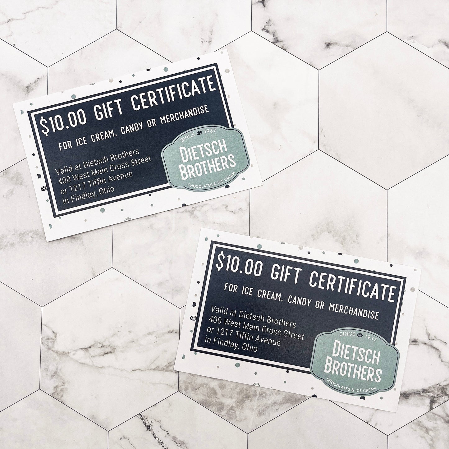 Two Dietsch Brothers gift certificates on a marble surface