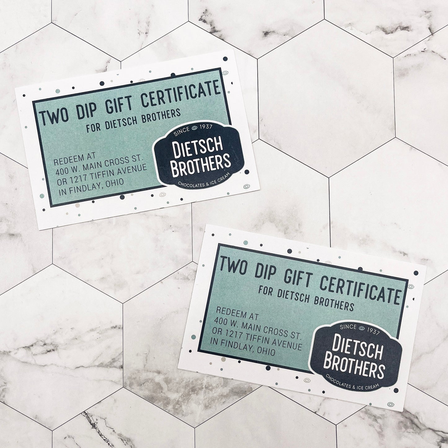Two Dietsch Brothers gift certificates on a marble surface