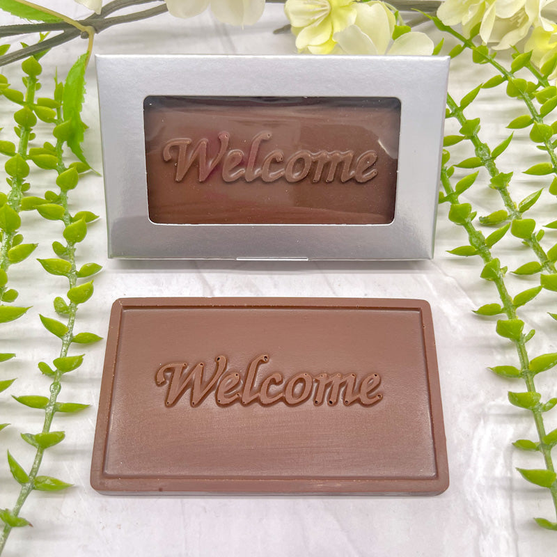 Milk chocolate bar that features raised text "Welcome" across it